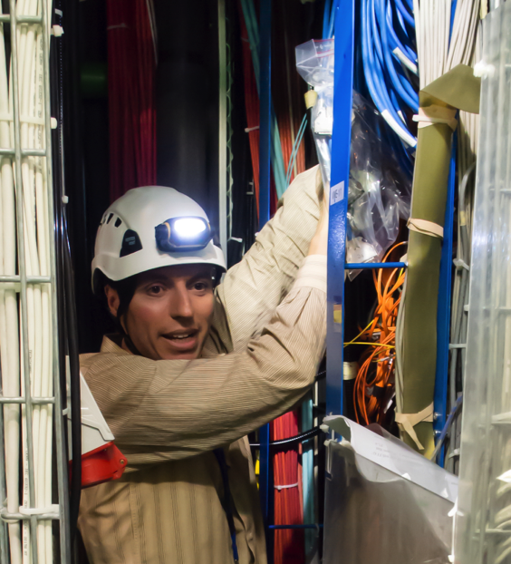 Manuel Franco Sevilla installs ODMB modules into the CMS detector at CERN. (Photo: Jeff Richman)