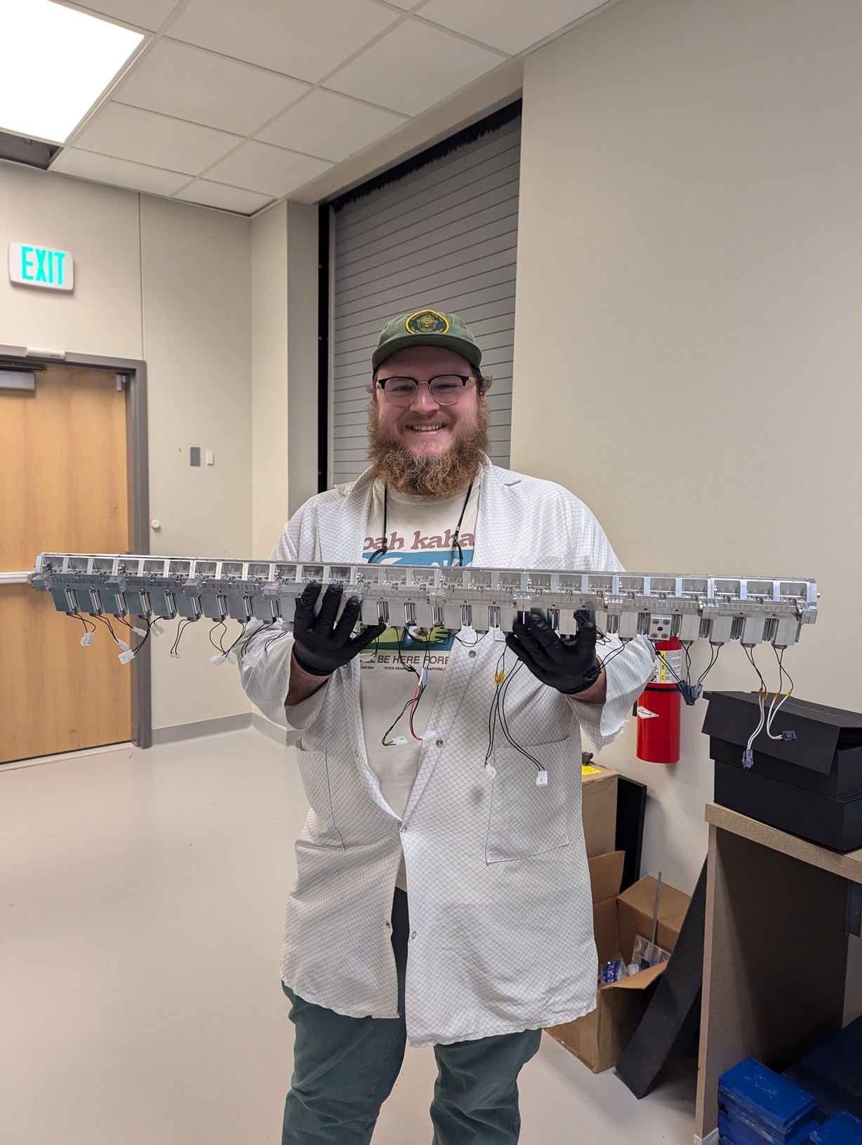 Jaron Shrock holds newly-developed equipment. Jaron Shrock holds newly-developed equipment.