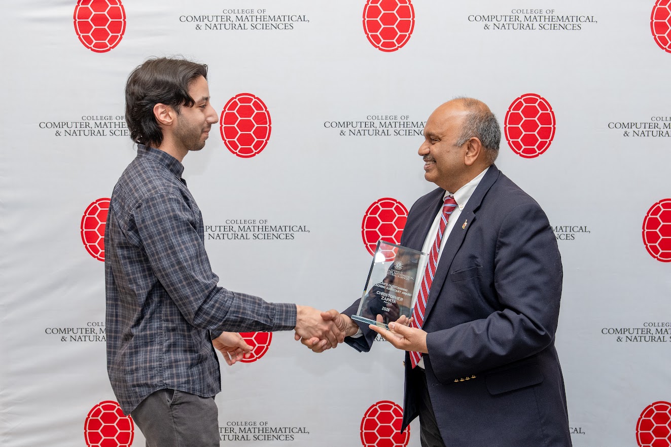 Chris Zapata receives congratulations from CMNS Dean Amitabh Varshney.